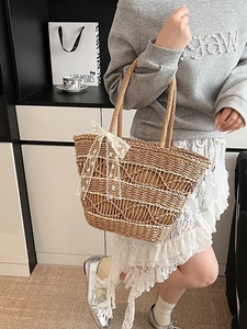 Fashionable woven tote bag with white lace bow detail for summer beach and daily use