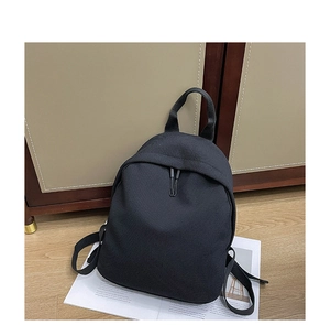 Side view of black oxford fabric backpack with mesh texture and top handle detail