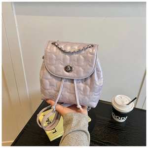 Detailed view of lavender star-quilted mini backpack with silver turn-lock and drawstring