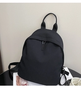 Detail of breathable mesh texture and adjustable straps on black casual backpack