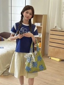 Green floral nylon crescent shoulder bag with lace bow accessory for a stylish outfit