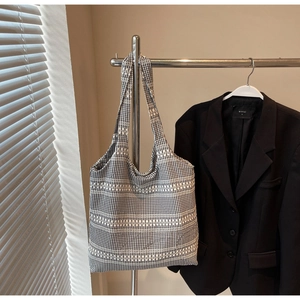Detail of black and white houndstooth tote bag texture and woven stripe design