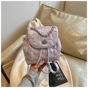 Detail of lavender star-quilted mini backpack with silver twist lock and chain handle