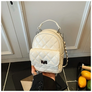 Detail of quilted leather mini backpack in beige with silver metal twist lock closure