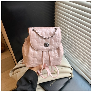 Detailed view of pink star-quilted leather backpack with silver chain and metal clasp