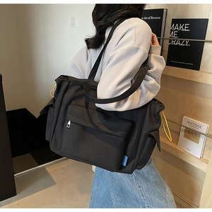 Black large capacity shoulder bag with yellow drawstring and practical side pockets