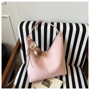 Detail view of pink PU leather Hobo tote bag with a cute brown plush bear pendant