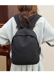 Women's black oxford fabric backpack with textured finish for casual travel and daily use