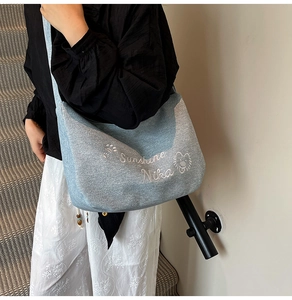 Détail du sac cabas en toile bleu clair avec broderie blanche Sunshine Nika et motifs