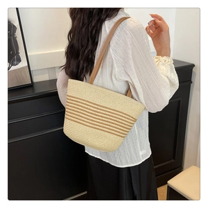 Fashionable summer straw tote bag with brown horizontal stripes and leather straps