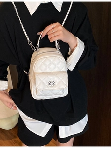 White quilted diamond pattern mini backpack with silver twist lock and chain strap