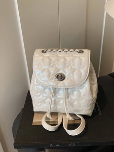 White star quilted backpack with metallic chain and silver turn-lock closure