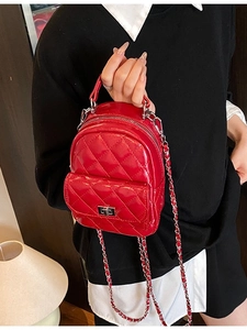 Fashionable bright red quilted mini backpack with glossy finish and chain strap details