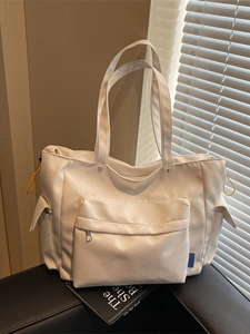 White high-capacity tote bag with side pockets and shoulder strap for daily commuting