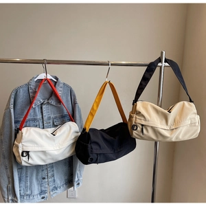 Detailed comparison of sporty nylon pillow bags in black, white, and beige colors