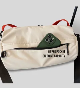 Detail view of large cream nylon bag showing exterior zipper pocket with green phone inside