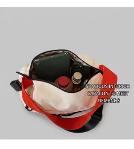 Detailed interior of the spacious crossbody bag showing storage for tablet and essentials