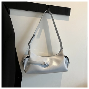 Close-up detail of grey glossy shoulder bag featuring stylish side pockets and metallic buckle