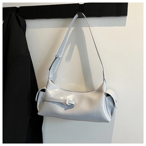 Detail view of light gray faux leather underarm bag with double side pockets and glossy finish