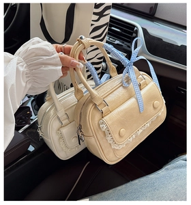 Detail of mini leather bags with lace edges and checkered ribbons in a car interior