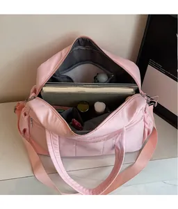Detailed view of the pink quilted travel bag showing spacious inner compartments for storage