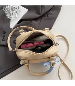 Top view of cream crossbody bag interior showing spacious main pocket and texture