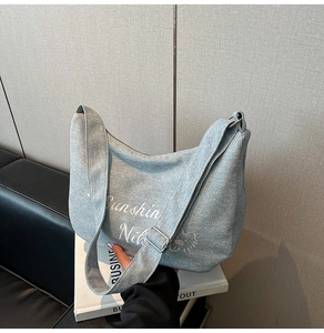 Détail du sac croissant bleu clair avec imprimé Sunshine et motif d'ours en peluche
