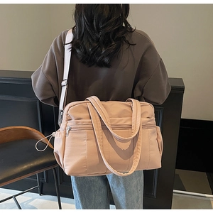 Rear view of model wearing a pink large capacity travel bag with quilted nylon texture