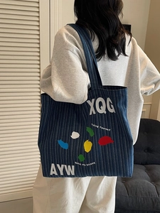Denim tote bag with striped pattern and artistic paint splash graphics for women