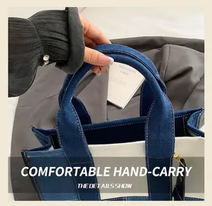 Detail of sturdy round handles and metal hardware on contrast denim patchwork tote bag