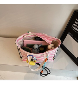 Spacious pink striped canvas tote bag showing interior storage for daily essentials