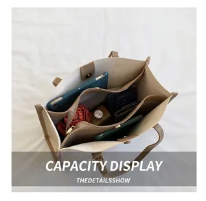 Internal view of a large beige tote bag showing multiple compartments and storage capacity