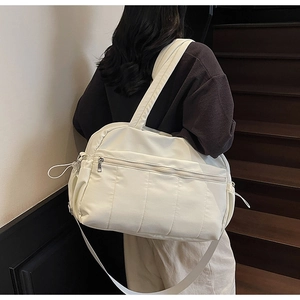 Off-white large travel bag with quilted details and side drawstring on shoulder strap