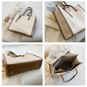 Detail view of contrast tote bag with protective gold studs and interior zip compartment