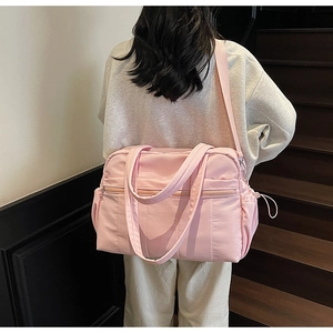 Detailed back view of a pink large capacity travel duffel bag with shoulder strap