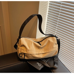 Detail of the high-capacity nylon crossbody bag with adjustable wide black strap