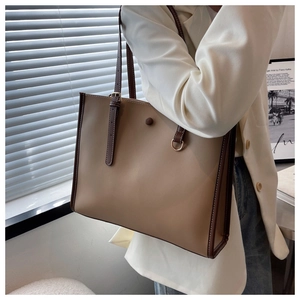 Detail of the high-quality synthetic leather texture and contrast stitching on tote bag