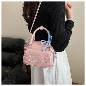 Detail of pink PU pillow bag featuring lace pocket and blue gingham ribbon bow