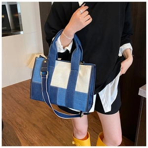 Detail view of denim patchwork tote bag showing color blocks and stitching quality