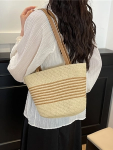 Chic beige and brown woven straw tote bag with shoulder straps for summer beach vacations