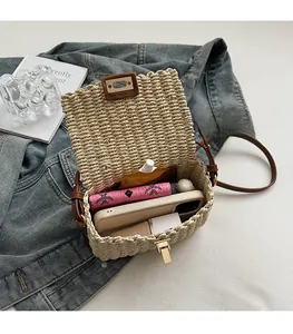 Detail of beige woven crossbody bag showing interior capacity for phone and lipstick