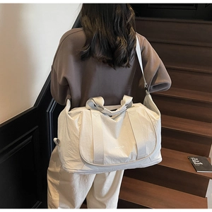 Vue détaillée d'un sac de voyage en nylon crème pour le yoga avec bandoulière réglable