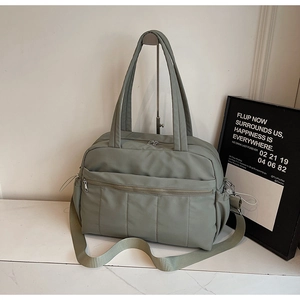 Olive green travel duffel with water-resistant quilted fabric and multi-pocket layout