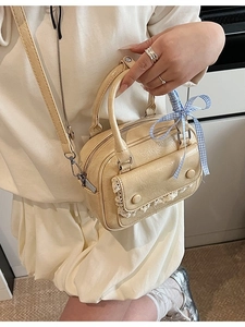 Creamy chic crossbody pillow bag with lace trim and blue checkered bow accessory