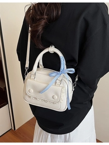 Elegant cream crossbody bag with lace flap and blue checkered bow detail for women