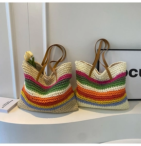 Macro detail of hand-woven rainbow straw tote bag with premium leather handles