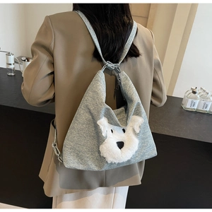 Grey knit backpack with cute plush schnauzer dog decor shown on a model's back