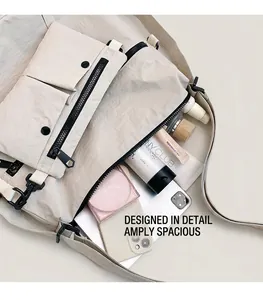 Internal view of off-white multi-pocket tote bag showing storage for cosmetics and phone