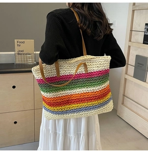 Detailed back view of a rainbow woven tote bag with brown leather straps for summer vacations