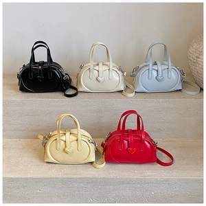Five colors of mini Boston bags with heart buckles on stone stairs display